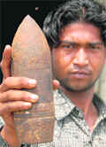 A worker at the Dadumajra garbage plant shows the bombshell on Saturday.
