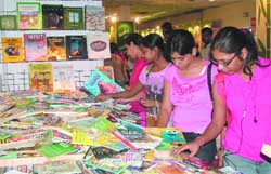 Visitors check a stall on the first day of the Delhi Book Fair at Pragati Maidan