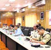 Uttarakhand DGP Subhash Joshi ( in blue shirt) holds a video-conference with district police chiefs in Dehradun on Saturday.