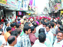 Police officials appeal members of the Jain community to open their shops in the Jalandhar cantonment on Saturday.