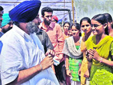 Deputy CM Sukhbir Badal interacts with students at Ghubaya village in Jalalabad on Saturday.