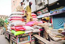 Pakistani labourers load bags of sugar onto a truck in Karachi on Sunday. A sugar crisis in Pakistan has wrong footed the political leadership as mills owned by lawmakers are blamed for compounding the miseries of Pakistanis and housewives struggle to sweeten the Eid festival
