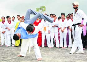 A student of Bhai Kanhaiya Institute exhibits a move during a tae kwon do camp in Patiala