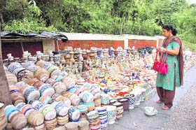 A women selects chinaware utensils displayed by a vendor in Dehradun