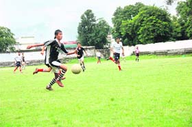 A player in action at the District Football League in Dehradun