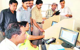Officials give training on e-ticketing to bus conductors at the Haridwar transport depot
