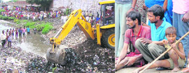 Rescue operations under way at the site where a boy drowned in a nullah in Karnal on Sunday; and (right) the victims father (left) being consoled by a friend.