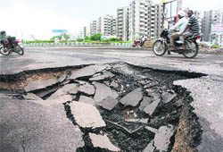 A portion of a road that got damaged due to heavy rain in Sector 47, Gurgaon, on Sunday.