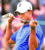 Tiger Woods reacts after missing his birdie putt on the 16th hole during third round play of The Barclays golf tournament in Jersey City, New Jersey on Saturday.
