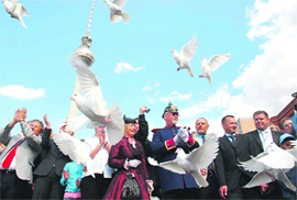 People watch 70 white pigeons being released during an event marking the 70th anniversary of the start of World War-II in front of the television tower in Berlin on Sunday.