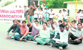 Members of the Junior Doctor Association block the Sangrur road in Patiala on Monday.