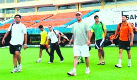 Players take field for a practice session at the PCA Stadium in Mohali on Monday.