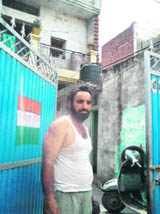 Jeet Singh with the BPL mark on the gate of his double-storeyed house. He runs a dairy. 