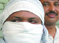 The Delhi police presents Jaswant Singh, accused of raping a teenager in Germany 12 years ago, in New Delhi on Monday.