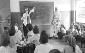 Volunteer students of Oxford University interacting with schoolchildren in a class at Standard Public High School, Dhulka, near Amritsar 