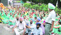 Health workers, employed under the NRHM, stage a protest on being relieved from duty without prior notice in Ludhiana on Monday.
