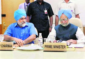 Prime Minister Manmohan Singh and Deputy Chairman of Planning Commission Montek Singh Ahluwalia during a full Planning Commission meet in New Delhi