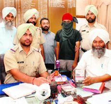 Cops show the instrument that was used for stealing power at Rajpura on Tuesday.