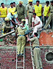Firemen and civil defence personnel take out an injured person from the debris in New Delhi on Tuesday.