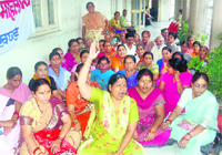 Women activists hold a dharna at the District Magistrate Office on Tuesday