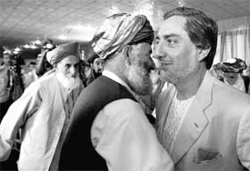 Abdullah Abdullah (right), top challenger against Afghanistan President Hamid Karzai in presidential election, is greeted by Pashtun supporters from Southern Afghanistan at a meeting in Kabul
