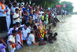 Devotees watch an idol of Lord Ganesha being immersed in the Sirhind canal in Bathinda on Wednesday. 