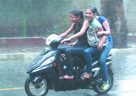 Girls enjoy the rain in New Delhi