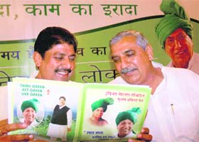 INLD General Secretary Ajay Chautala and state unit president Ashok Arora go through the party manifesto for the Haryana Assembly elections released in Chandigarh