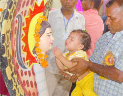 A child pays obeisance at Baba Sodal Mandir in Jalandhar on Wednesday. Tribune photo: Malkiat Singh