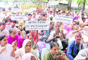 Trade unions, industrial workers, teachers, employees and farmers stage a dharna against price rise and power cuts in Ludhiana on Wednesday.
