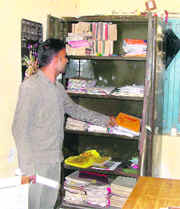 Cashier Satnam Singh shows the almirah where the keys of the safe and cash at the ITI of Manuke village near Jagraon were kept.