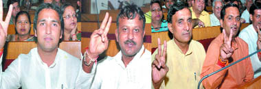Newly elected councillors Deepak Chaudhary, Kishan Pahelwan, Vijay Solanki, Devender Kumar and Mahender Jain show victory sign after taking oath at Town Hall in New Delhi on Thursday.