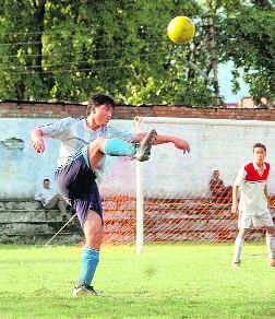 A player attempts a goal at the District Football League in Dehradun on Thursday.