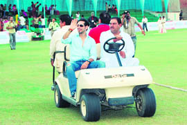 Actor Dino Morea waves at a crowd at the inauguration of T-20 tournament in Sirsa.