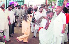 Guga followers beat their bodies with bunches of iron chains at Guga Mari, Chhapar