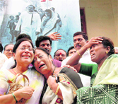  Party workers grieve outside party headquarters in Hyderabad on Thursday