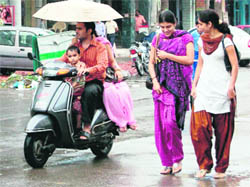 Girls caught in rain in Amritsar on Thursday