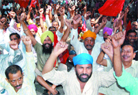 Labour unions, led by the CITU and AITUC, raise slogans against the government in Amritsar on Friday