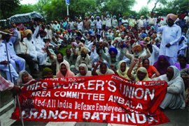 Members of the MES Workers Union holding a protest in support of their demands in Bathinda on Friday. 