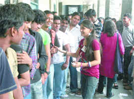 Students of Ramjas College queue up to cast their votes during the DUSU elections in New Delhi on Friday. 