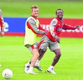 Englands David Beckham (L), tackles Shaun Wright-Phillips during a training session for the England national soccer team at London Colney on Friday. 