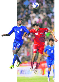 Indias N.P Pradeep(left) and Syrias Feras Ismail jump for the ball during the Nehru Cup final match.