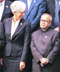 Finance Minister Pranab Mukherjee shares a light moment with French Finance Minister Christine Lagarde during a group photo at the G20 Finance Ministers summit in London