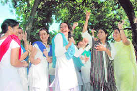 Supporters of the winning candidate celebrate at the MKP College in Dehradun on Saturday.