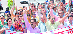 Teachers hold a protest on Teachers Day in Karnal on Saturday.