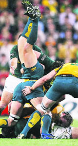    Australian Wallabies' Adam Ashley-Cooper is flipped upside down during their Tri Nations rugby union test match against South Africa in Brisbane on Saturday.