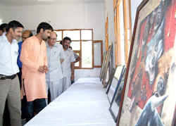 Guests have a look at Gurpreet's paintings and photographs at the DAV College in Abohar.
