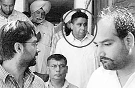 Promoter of Sunny Enclave Jarnail Singh Bajwa (encircled) coming out of the court of SDM, Kharar, after being granted bail on Sunday.