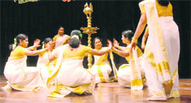 Kerala women perform thiruvathira, a traditional dance, during Onam celebrations in Dehradun on Sunday.