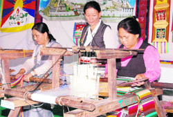 Tibetan women prepare handwoven aprons in Dehradun on Sunday.